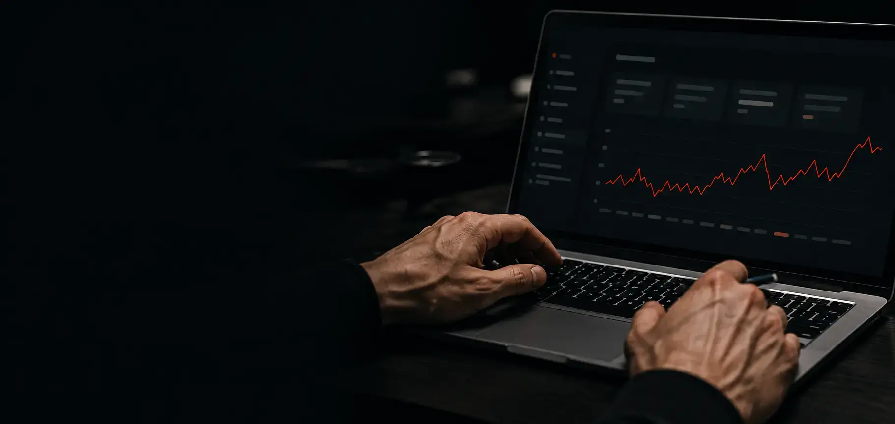 Hands typing on a laptop showing a Search Console performance chart climbing