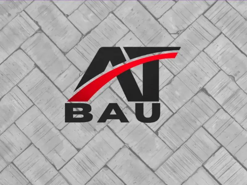 AT BAU logo over grey herringbone paving, from the homepage built for the firm